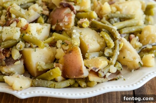 Slow Cooker Green Beans and Potatoes with tender vegetables and savory bacon.