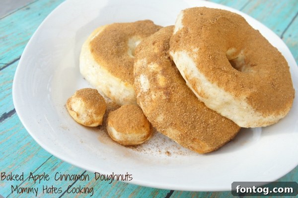 Close-up of baked apple cinnamon doughnuts coated in glaze and cinnamon sugar