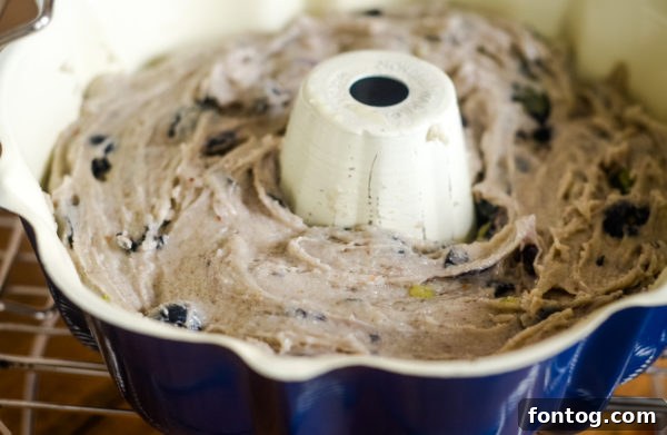 Bowl of gluten-free blueberry bread batter before baking, showing its thick consistency
