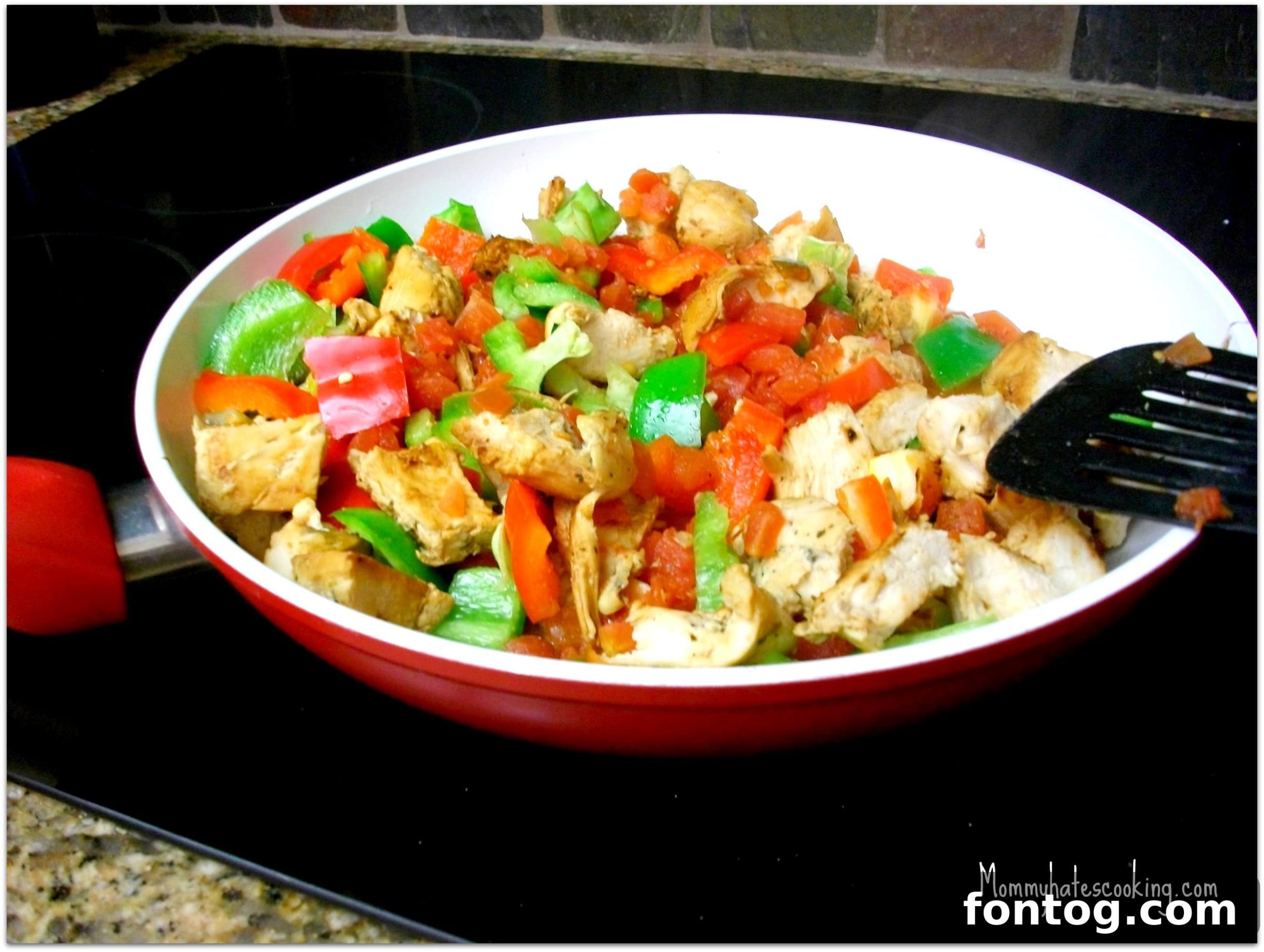 Sizzling Chicken Fajitas in a Skillet with Bell Peppers and Onions