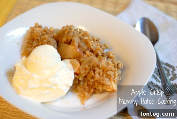 Warm and inviting baked apple crisp, topped with a golden brown oat crumble, ready for a scoop of ice cream.