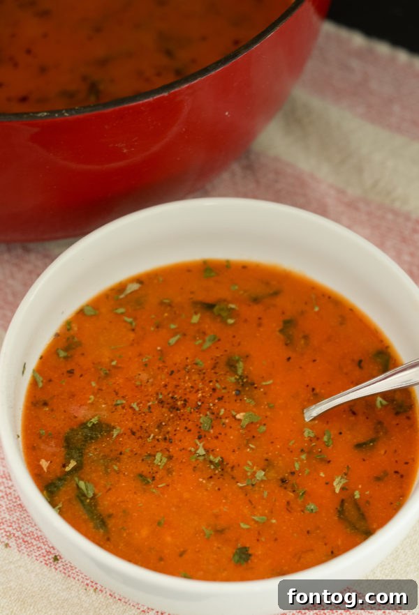 A bowl of gluten-free creamy tomato florentine soup.