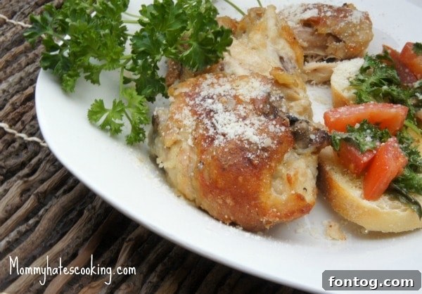 Parmesan Oven Fried Chicken with a side of green beans, ready to serve.