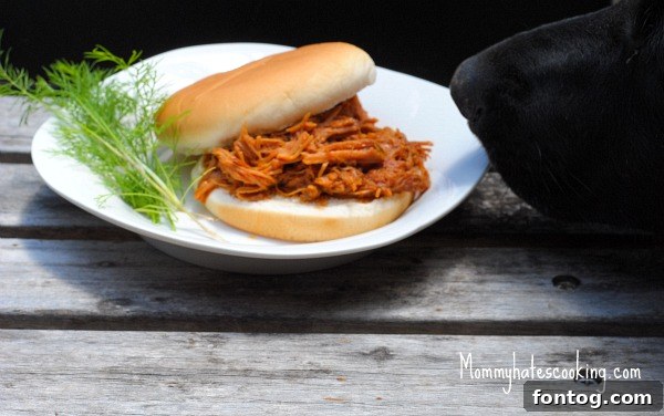 A playful black lab attempting to snatch food from a table.
