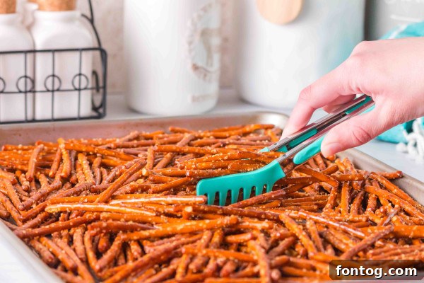 seasoned pretzels in a baking sheet after coating
