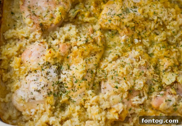 A baking dish with rice, chicken, and maple sauce, ready to be baked.