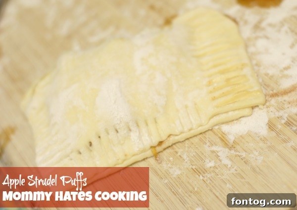 Apple filling placed on half of a puff pastry sheet before folding