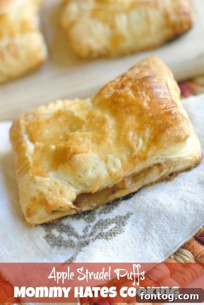 Baked apple strudel puffs with a golden crust on a baking sheet