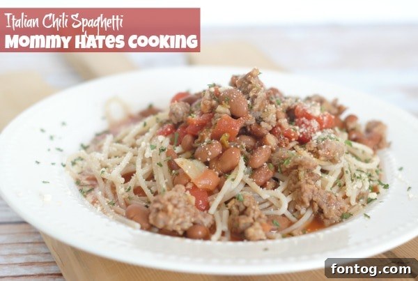 Italian Chili Spaghetti served in a bowl with grated Parmesan cheese