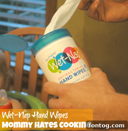 Wet-Nap wipes being used to clean a child's hands