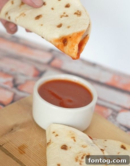 Two pizza quesadillas with marinara dipping sauce