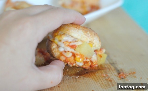 Easy Hawaiian Pizza Bagel Sliders 6 Finished Hawaiian Pizza Bagel Bites on a plate, ready to serve