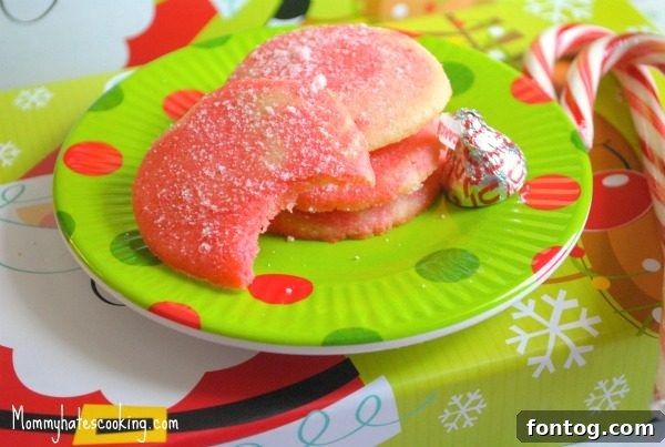 31 Joyful Christmas Cookie Recipes 4 Delicious Candy Cane Cookies arranged on a festive plate, showing their iconic red and white swirl pattern, perfect for holiday gatherings.