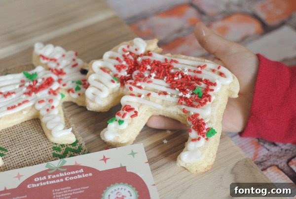 31 Joyful Christmas Cookie Recipes 7 A selection of decorated Christmas sugar cookies, including trees and stars, beautifully arranged for a holiday dessert spread.