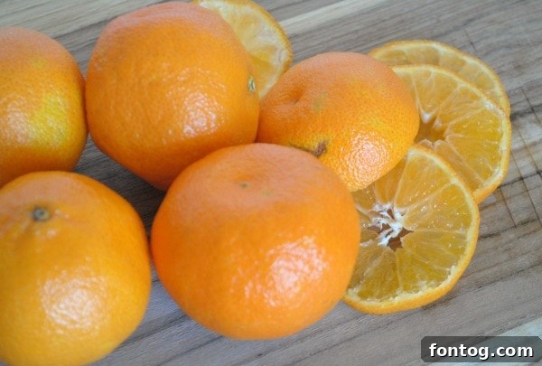 A child's hand reaching for a glass of Cranberry Orange Punch, highlighting its kid-friendly appeal.