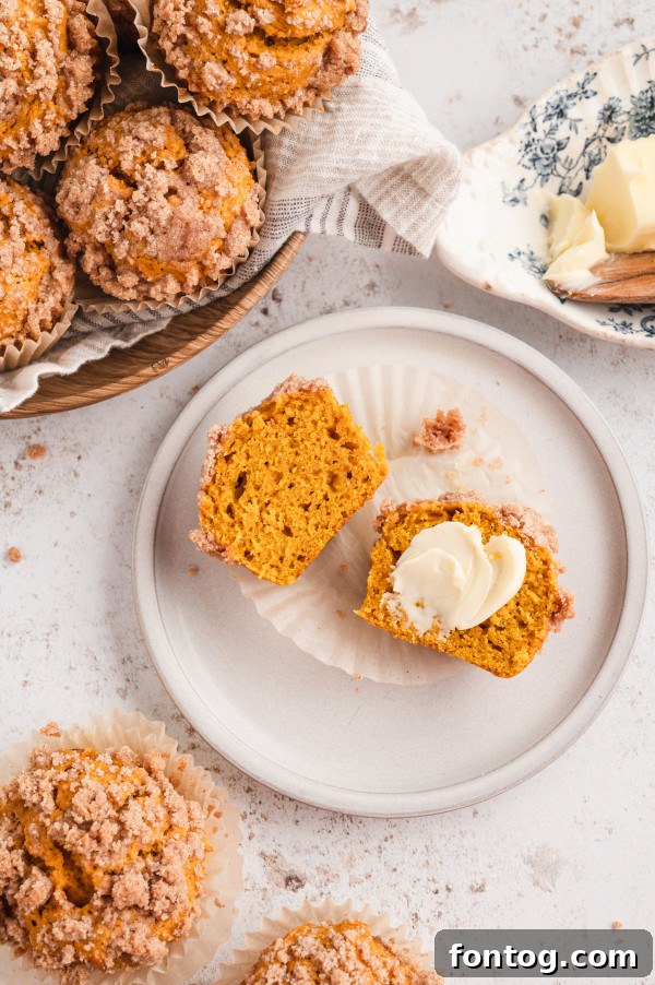 A close-up of a perfectly baked gluten-free pumpkin crumble muffin