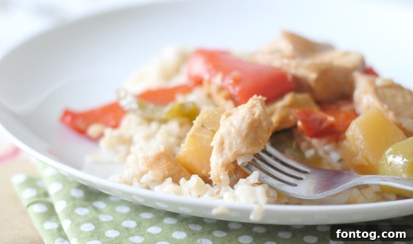 Easy Slow Cooker Sweet and Sour Chicken 4 Colorful sweet and sour chicken simmering in a slow cooker, ready for dinner.
