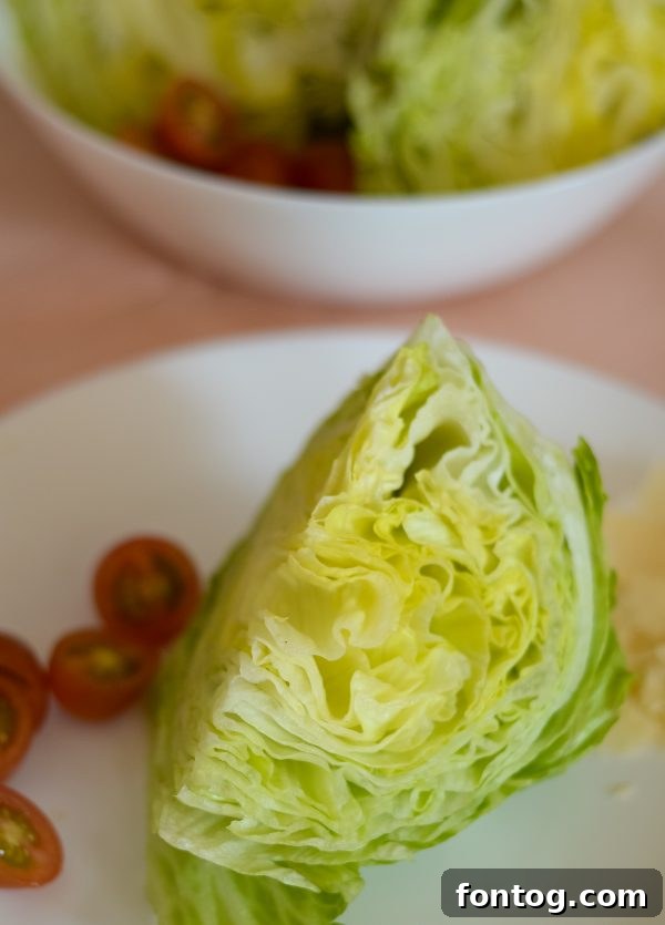 Iceberg lettuce being cut into wedges for salad