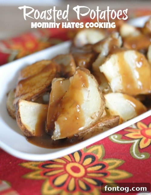 A serving of roasted potatoes with gravy on a plate