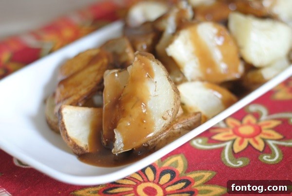 Close-up of roasted potatoes topped with brown gravy