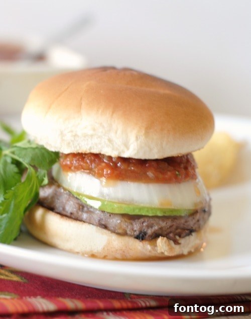 A close-up of a vibrant Spicy Salsa Burger with colorful toppings