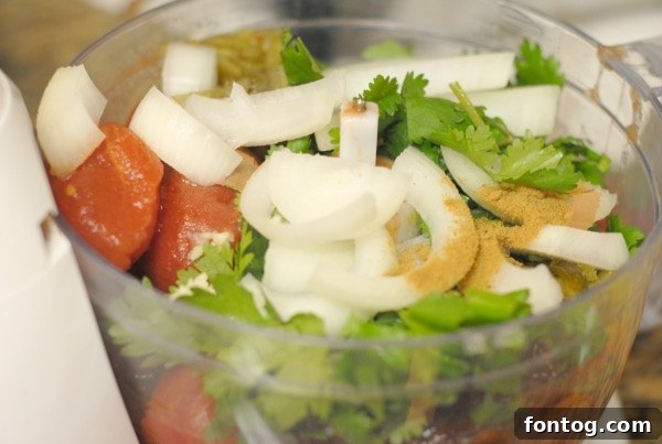 A bowl of freshly made spicy salsa, garnished with cilantro
