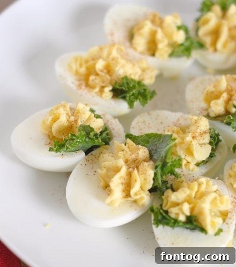 Delicious Kale Stuffed Deviled Eggs on a serving platter, perfect for any holiday gathering.