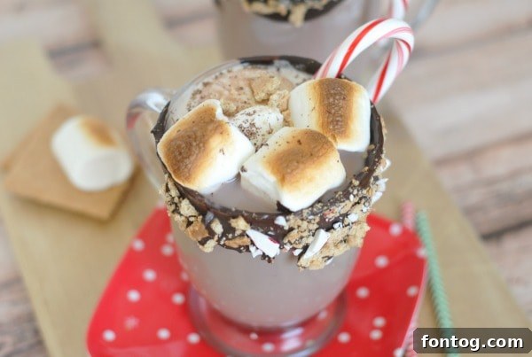 A child's hand reaching for a mug of hot chocolate, highlighting a cozy family moment.