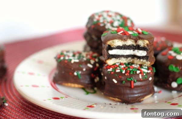 Several Oreo Stuffed Chocolate Covered Ritz Crackers on a white plate