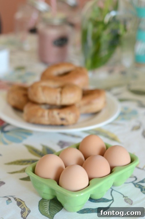 Effortless Party Breakfasts: Berry Orange Smoothies and More 11 A breakfast spread featuring a variety of dishes: fruit, biscuits, bagels, and a jug of fresh orange juice, alongside a basket of Pepperidge Farm Sweet Rolls.