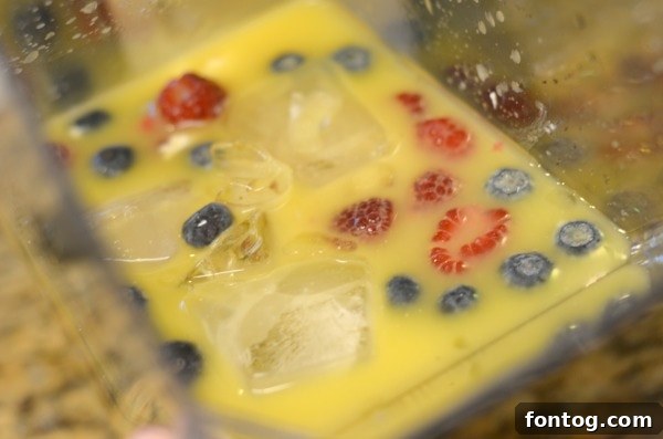 Effortless Party Breakfasts: Berry Orange Smoothies and More 13 A simple yet elegant breakfast setup with fresh orange juice, pastries, and berries, perfect for a relaxed morning gathering.