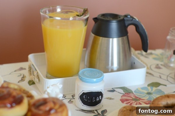 Effortless Party Breakfasts: Berry Orange Smoothies and More 17 A cozy coffee station featuring a unique cow-shaped creamer, alongside a mug and fresh orange juice, setting a warm ambiance for a breakfast gathering.