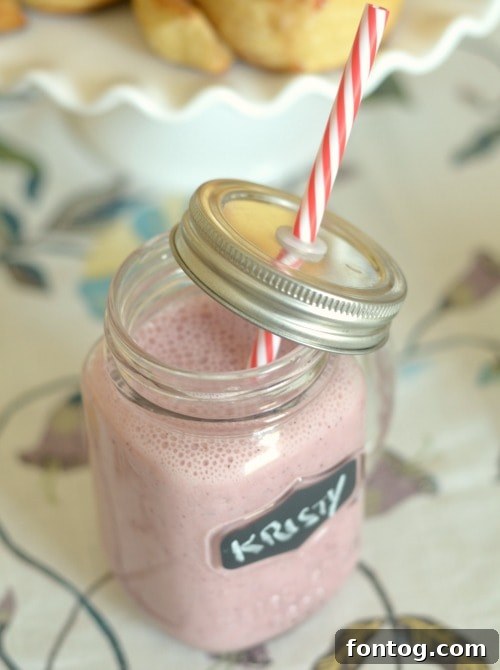 A refreshing Berry Orange Smoothie, perfectly blended and served in an elegant glass, highlighting its vibrant color and smooth texture, ready for a delightful brunch.