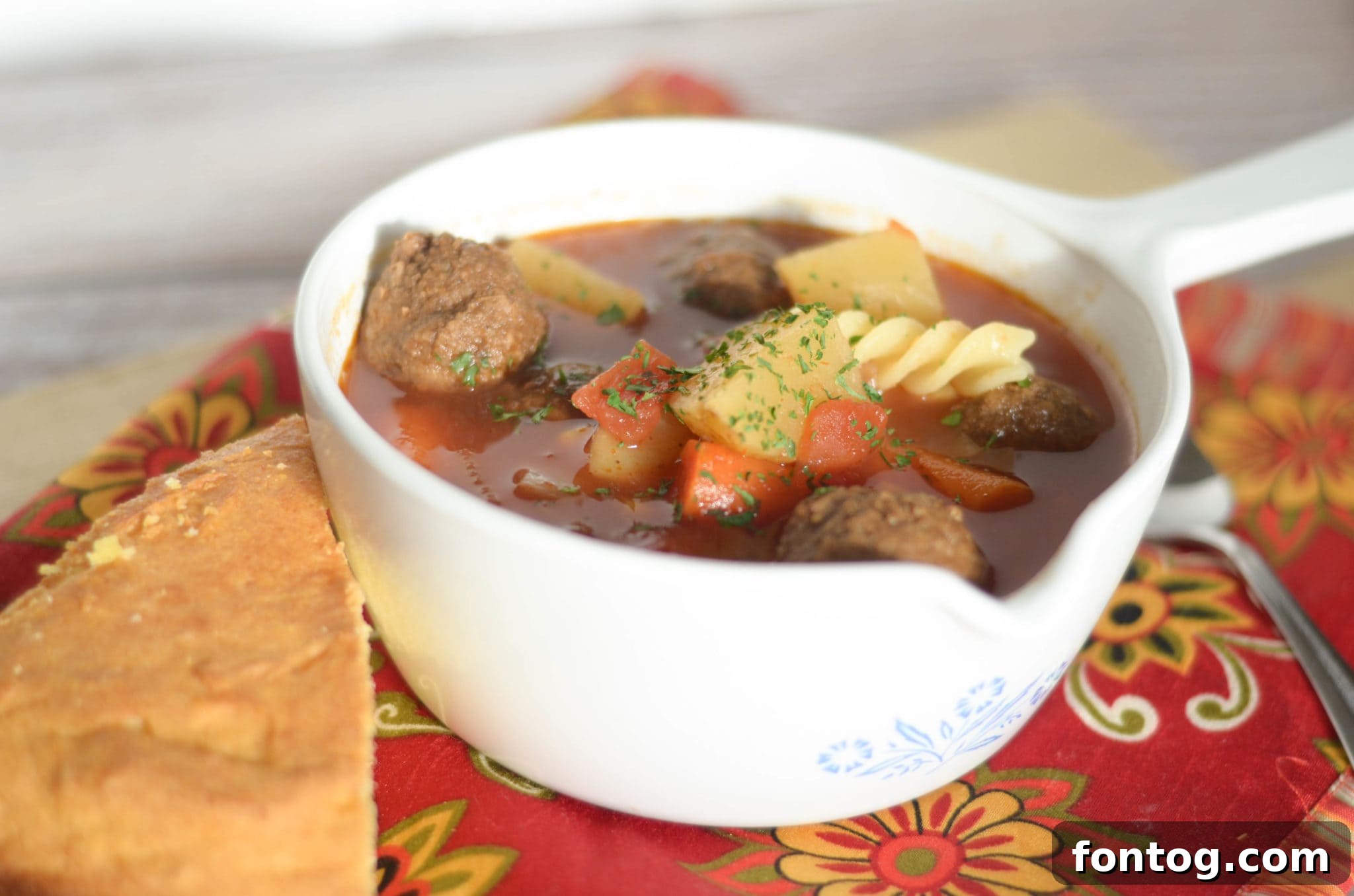 Meatball soup in a bowl with a spoon