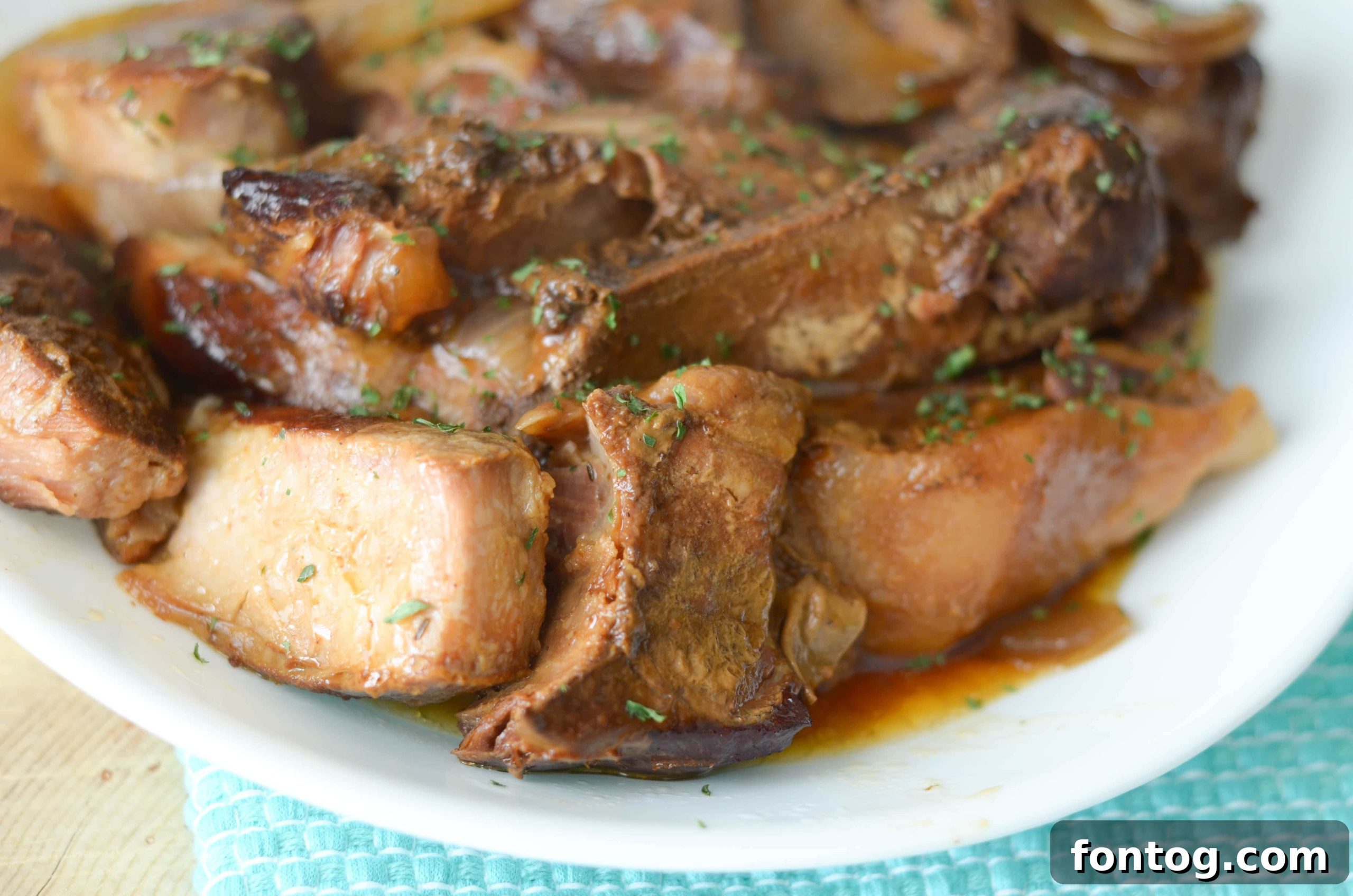 Slow Cooker Maple Honey Ribs - A close-up of tender ribs drenched in maple honey sauce.