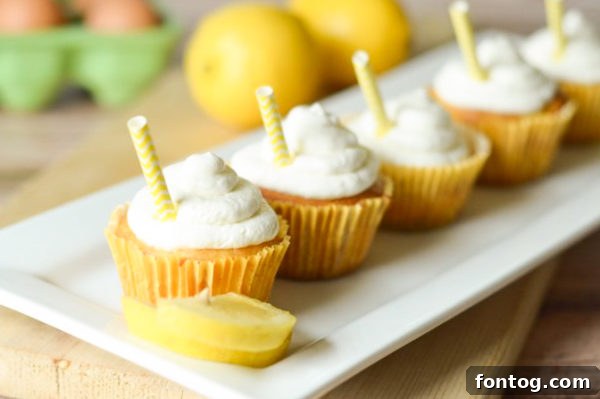 A close-up view of a frosted Strawberry Lemonade Cupcake, showing its moist texture and decorative elements, possibly for a special occasion.