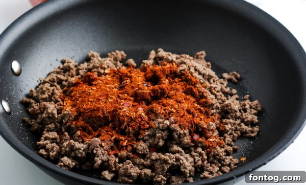Set-It-and-Forget-It Gluten-Free Taco Meat: Freezer-Friendly Meal Prep 4 Ground beef browning in a skillet before going into the slow cooker for taco meat
