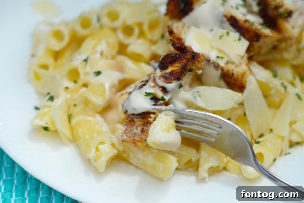 Blackened Chicken Alfredo served with fresh parsley garnish