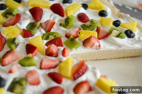 Gluten-free cookie dough rolled out on parchment paper in a baking pan.