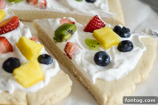 Gluten-Free Fruit Pizza topped with whipped cream and various fresh fruits.