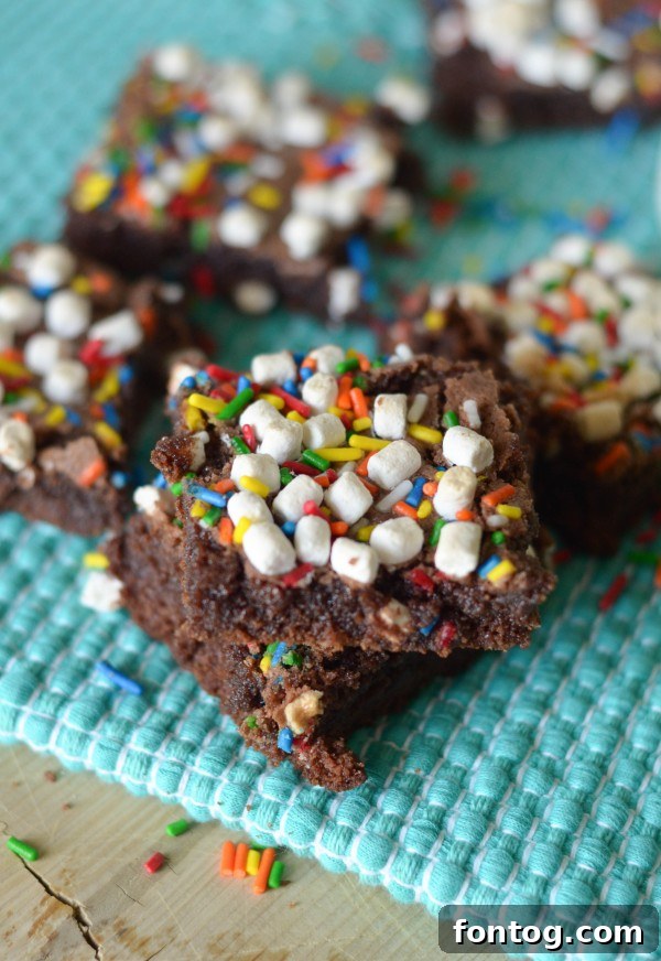 Decadent Hot Chocolate Brownies topped with marshmallows and sprinkles