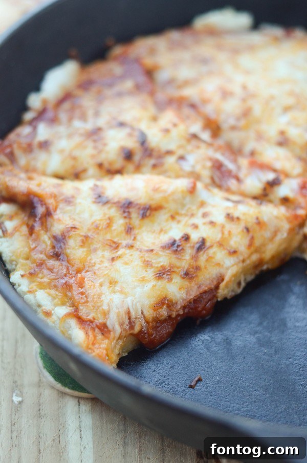 A delicious homemade Deep Dish Pizza, featuring a thick, golden crust and melted cheese, ready to be served.