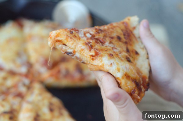 Deep Dish Pizza dough perfectly pressed into a cast iron skillet, showcasing its thick edges.