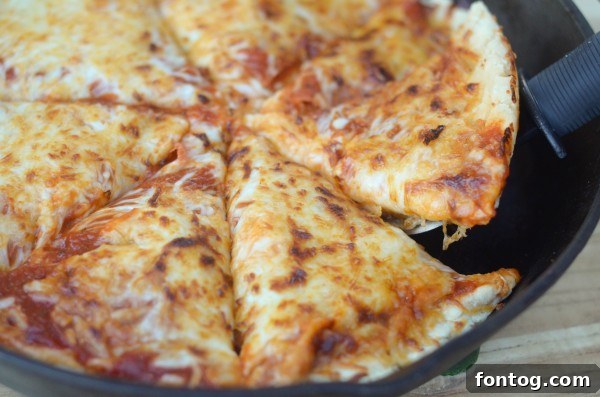 Deep Dish Pizza topped with classic ingredients like pepperoni and olives, ready for its final bake.