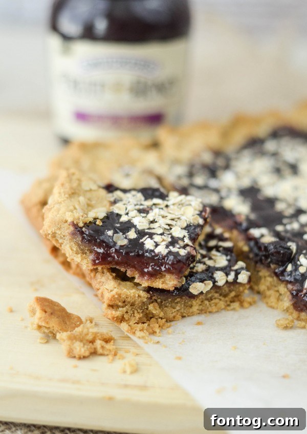 Peanut Butter and Berry Bliss Bars 7 Peanut Butter & Berry Bars sliced into squares on a plate