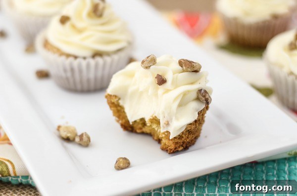 Stacked gluten-free carrot cake cupcakes with frosting, ready for serving