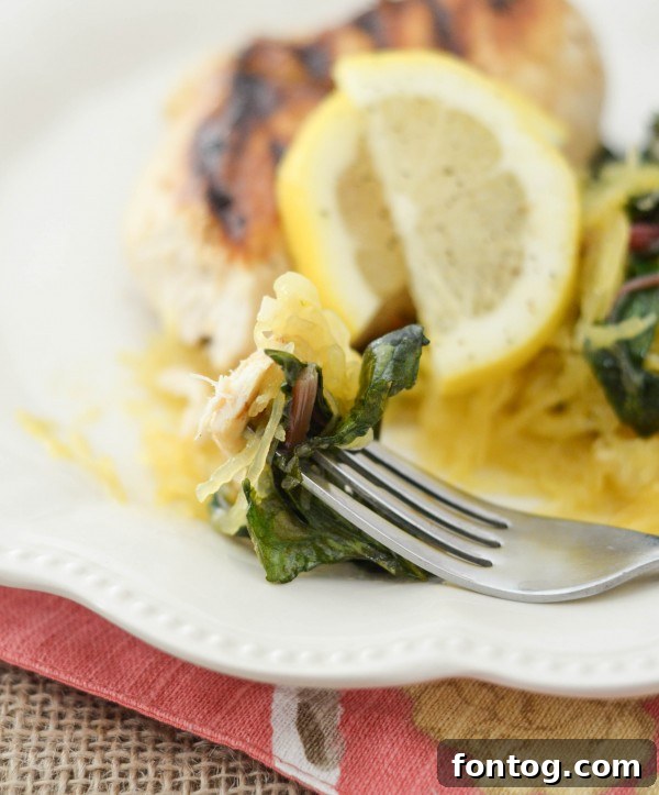 Plated Lemon Pepper Chicken with Sauteed Spaghetti Squash and Rainbow Chard, ready to be enjoyed.