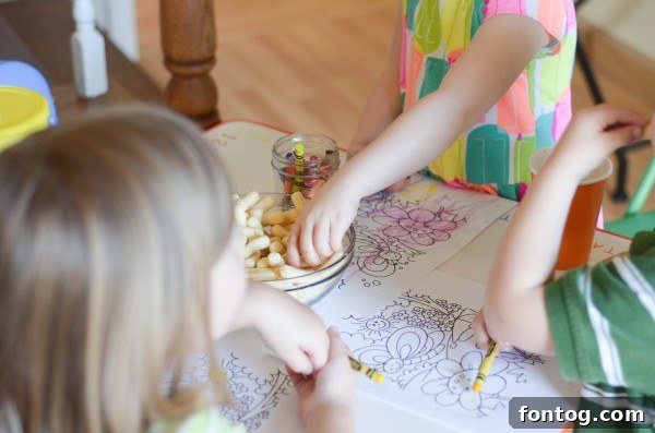 A close-up of a toddler's hand reaching for Gerber Lil' Beanies, emphasizing ease of self-feeding.
