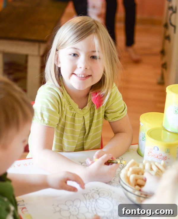 Close-up of a toddler enjoying Gerber Lil' Beanies while engaging in a play activity.