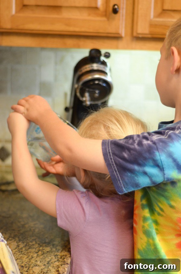 Fresh Bloom Cupcakes 5 Children happily decorating Spring Cupcakes with frosting and cheerful spring-themed toppings like edible chicks and eggs.